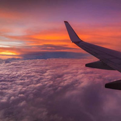 Tropical sunset in the sky, view from the plane